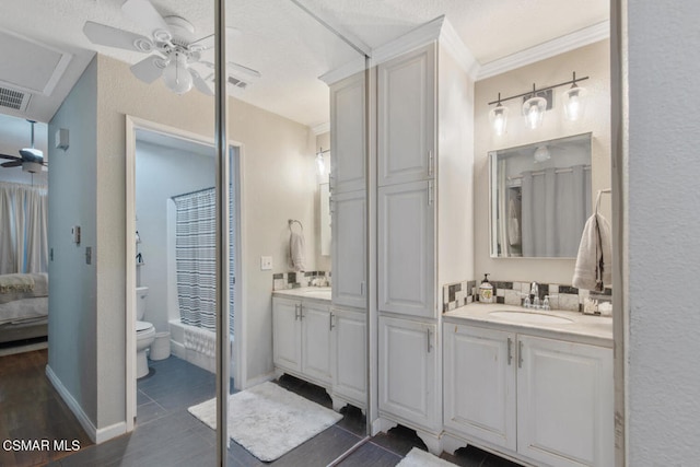 full bathroom featuring vanity, tub / shower combination, ceiling fan, and toilet