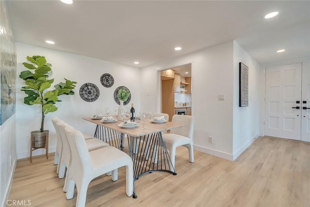 dining space with light wood-type flooring