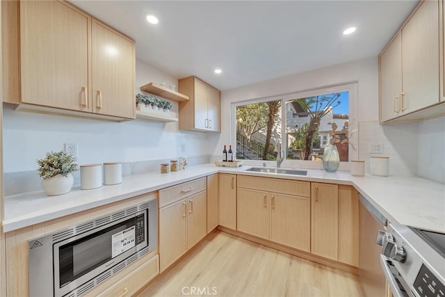 kitchen with sink, stainless steel appliances, and light brown cabinets