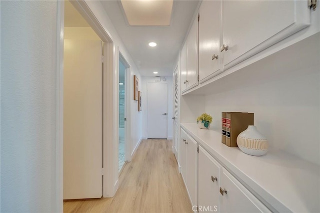 hallway with light hardwood / wood-style flooring