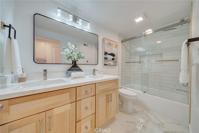 full bathroom with bath / shower combo with glass door, vanity, and toilet