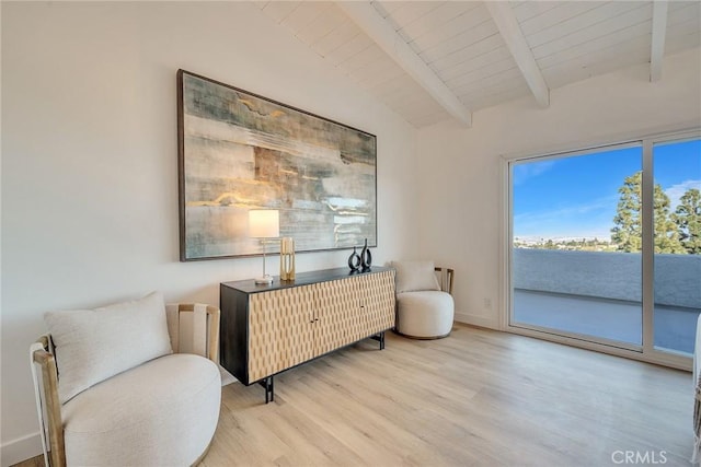 sitting room with wood ceiling, light hardwood / wood-style flooring, and lofted ceiling with beams