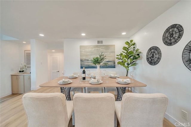 dining space with light hardwood / wood-style flooring