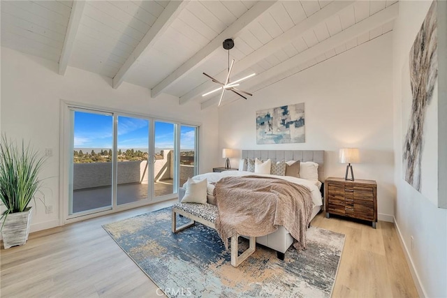 bedroom with light hardwood / wood-style flooring, a notable chandelier, access to outside, and lofted ceiling with beams