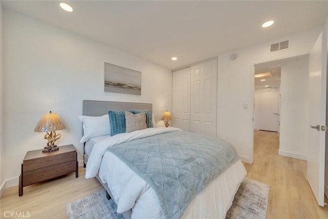 bedroom featuring wood-type flooring and a closet