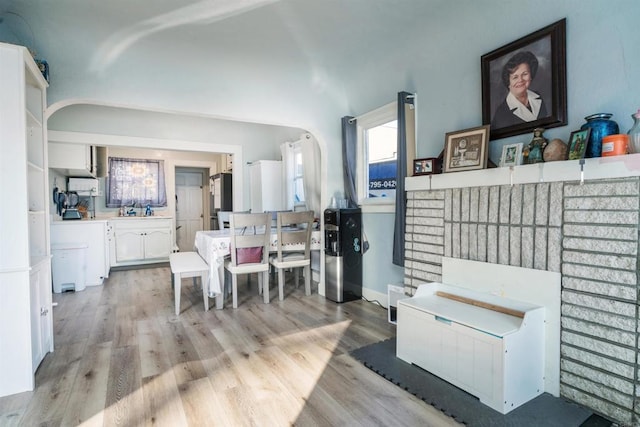 dining space with sink and light hardwood / wood-style flooring