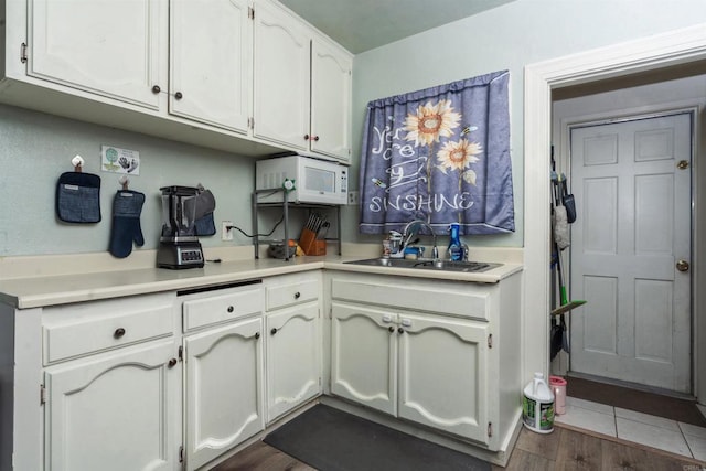 kitchen with white cabinetry, sink, and dark hardwood / wood-style flooring