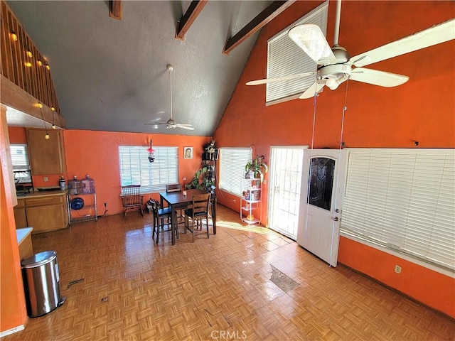 dining space with ceiling fan, plenty of natural light, high vaulted ceiling, and light parquet floors