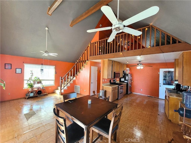 dining area featuring ceiling fan, high vaulted ceiling, light parquet flooring, and sink