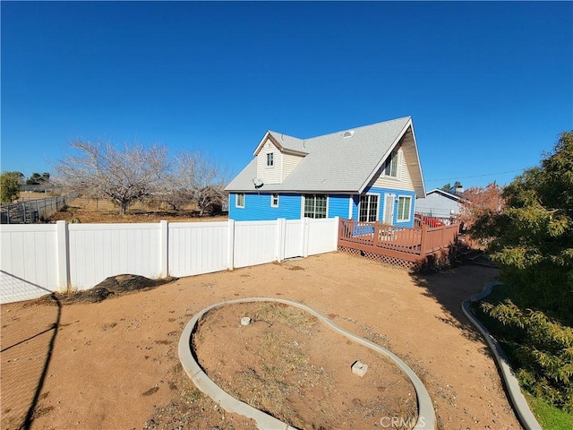 rear view of property with a wooden deck