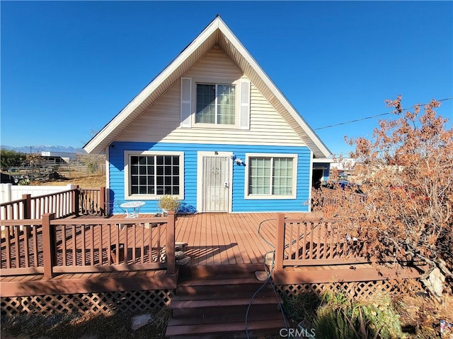 back of property with a wooden deck