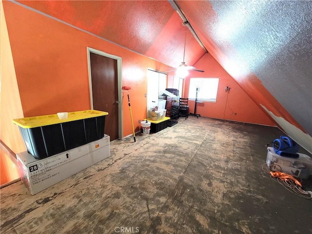 bonus room featuring ceiling fan, lofted ceiling, and a textured ceiling