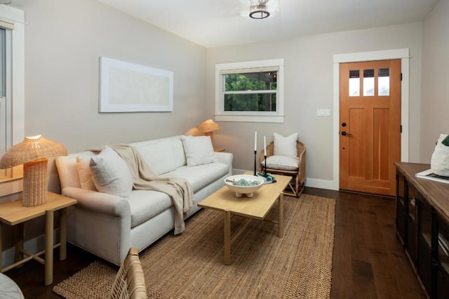 living room with dark wood-type flooring and a wealth of natural light