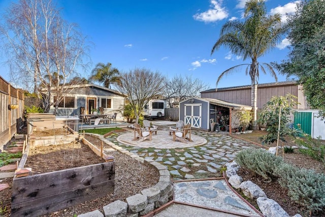 view of yard featuring a storage shed, a patio area, and an outdoor fire pit