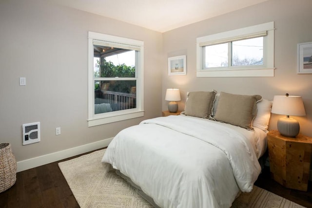 bedroom featuring hardwood / wood-style flooring and heating unit