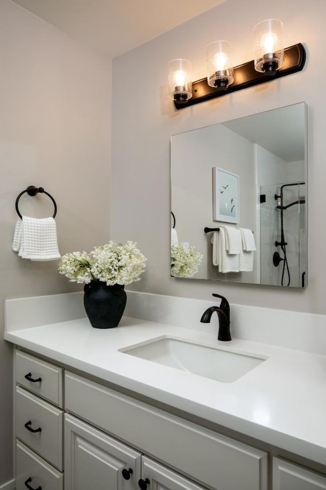 bathroom with vanity and a shower