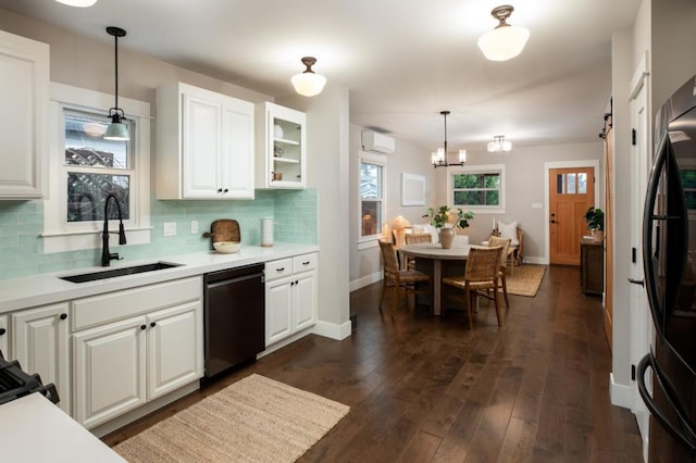 kitchen with white cabinetry, sink, pendant lighting, and black appliances