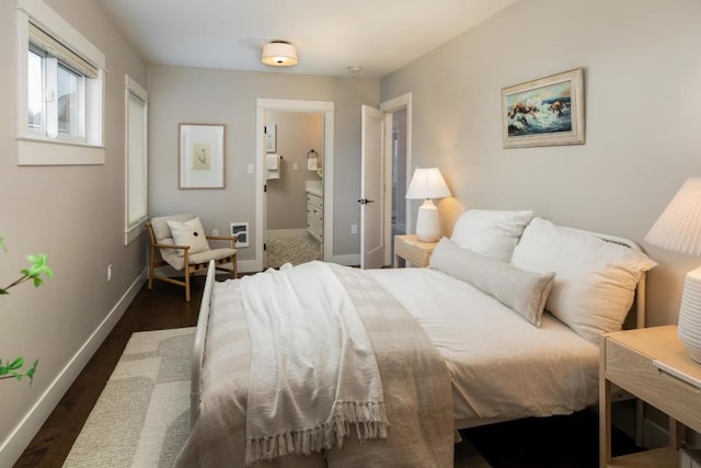 bedroom featuring dark hardwood / wood-style floors and ensuite bathroom