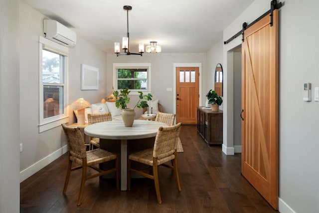 dining room featuring a barn door, dark hardwood / wood-style floors, a wall mounted AC, and an inviting chandelier