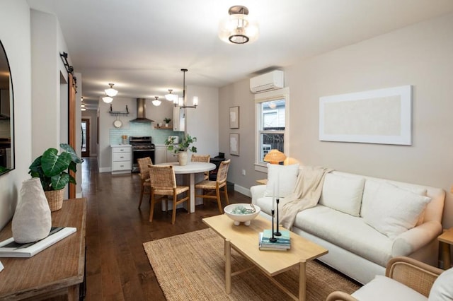 living room featuring dark hardwood / wood-style flooring, an AC wall unit, and a barn door