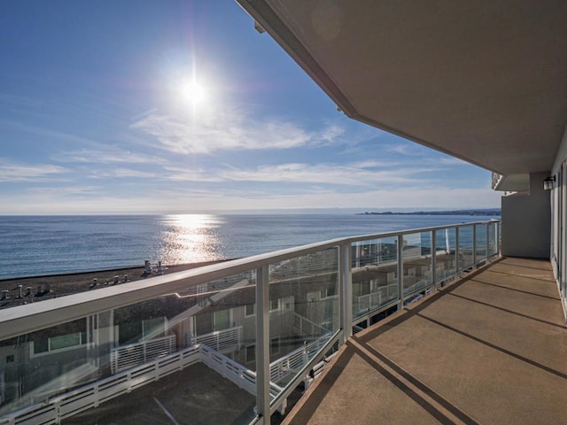 balcony with a beach view and a water view