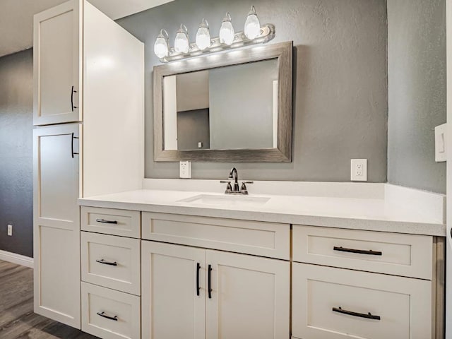 bathroom with vanity and wood-type flooring