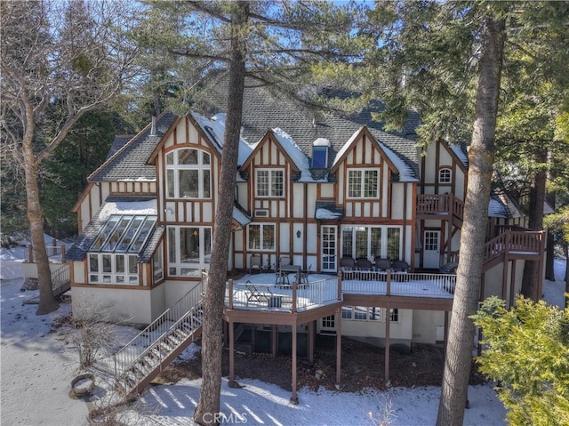 29223 Pigeon Hawk Ln, Lake Arrowhead, CA 92352 - back of property with a wooden deck, stairway, a sunroom, and a shingled roof