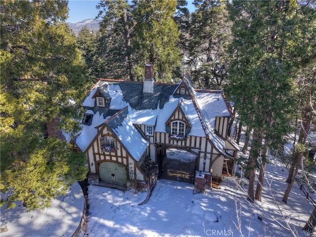 29223 Pigeon Hawk Ln, Lake Arrowhead, CA 92352 - tudor house with a chimney and stone siding