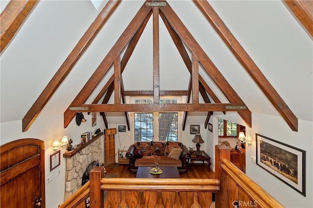 living room with a fireplace and lofted ceiling with beams