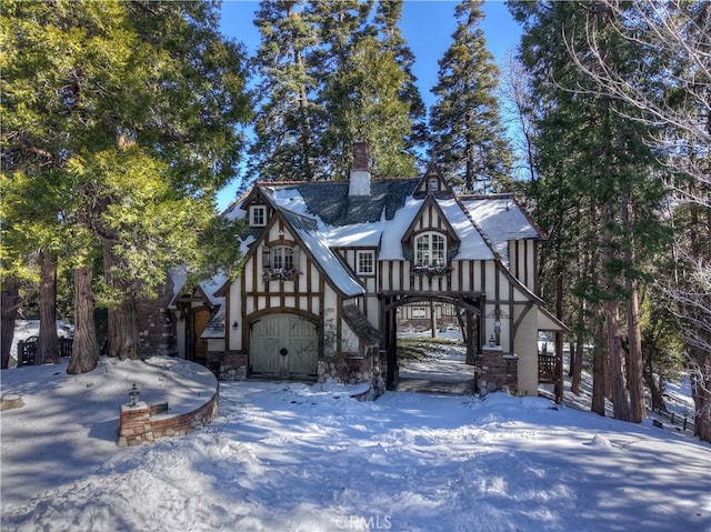 29223 Pigeon Hawk Ln, Lake Arrowhead, CA 92352 - tudor house with a chimney, stone siding, and stucco siding