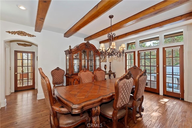 dining room with wood-type flooring, plenty of natural light, an inviting chandelier, and french doors