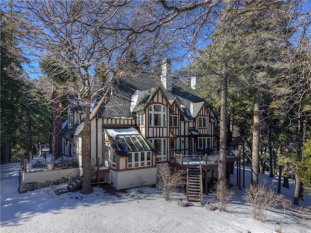 view of snow covered back of property