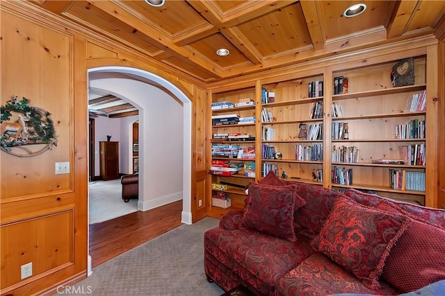 living area with beam ceiling, carpet, coffered ceiling, built in shelves, and wooden ceiling