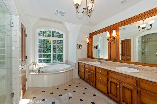 bathroom featuring an inviting chandelier, vanity, and independent shower and bath