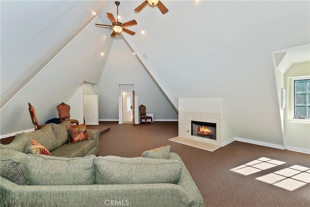 carpeted living room featuring ceiling fan, lofted ceiling, and a tile fireplace