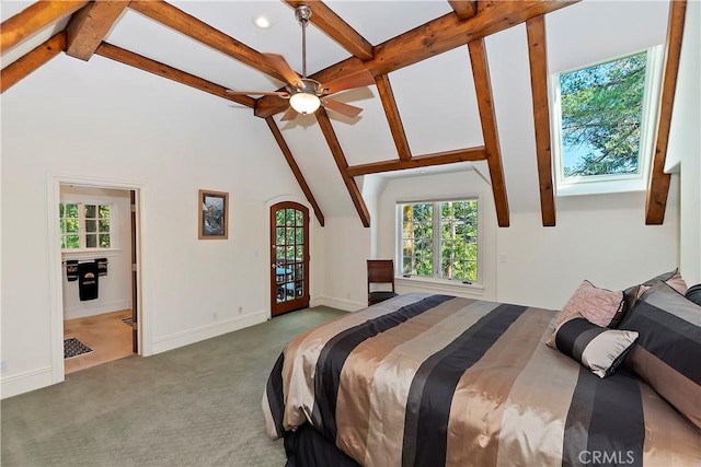 bedroom featuring vaulted ceiling with beams, ensuite bath, and carpet flooring