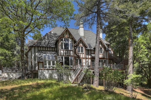 29223 Pigeon Hawk Ln, Lake Arrowhead, CA 92352 - back of property featuring stairway, a chimney, a wooden deck, and roof with shingles