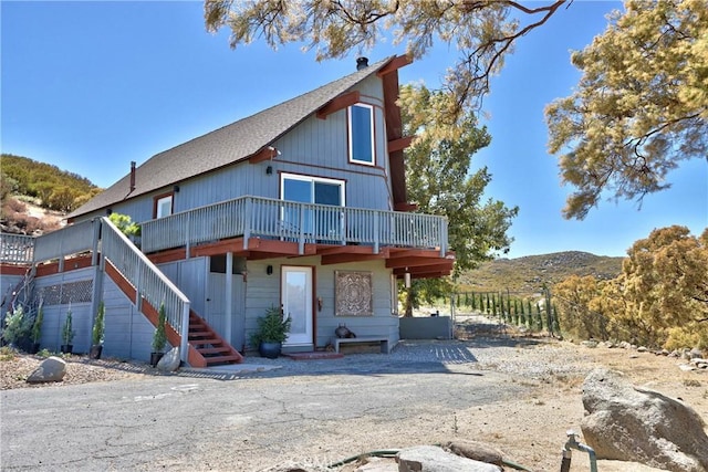 view of front of house featuring a deck with mountain view