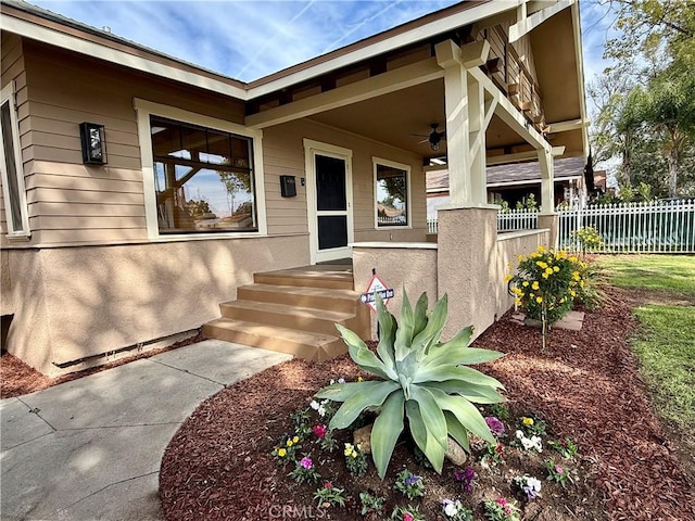 view of exterior entry with ceiling fan