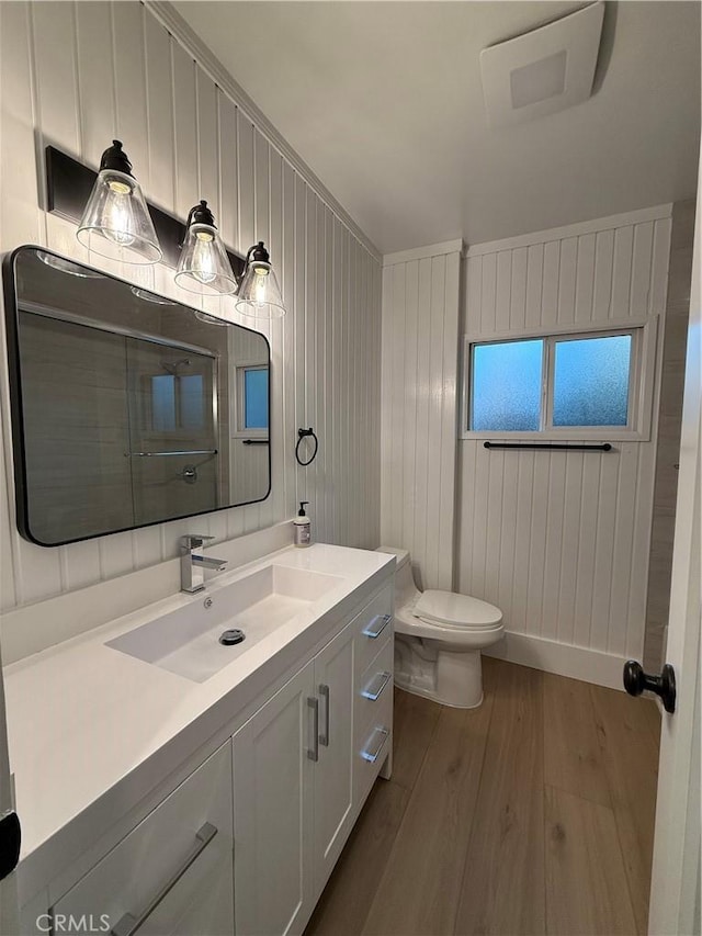 bathroom with vanity, hardwood / wood-style floors, and toilet