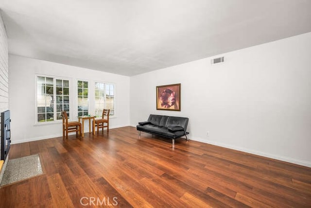 sitting room featuring a fireplace and dark hardwood / wood-style floors