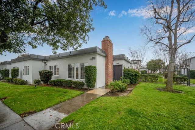 view of side of home with a yard