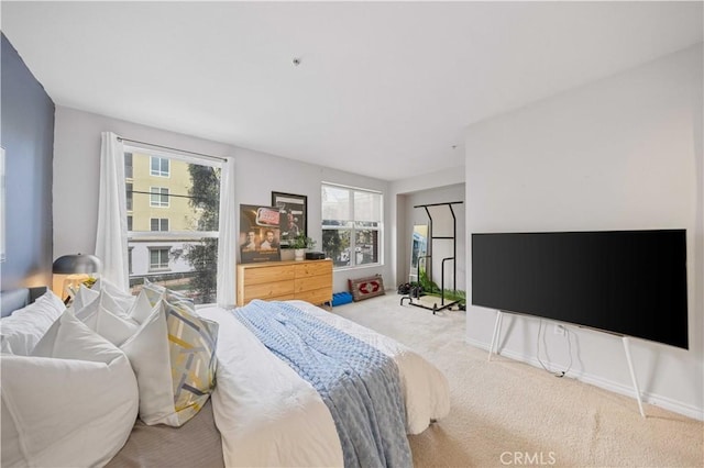 bedroom with light carpet and multiple windows