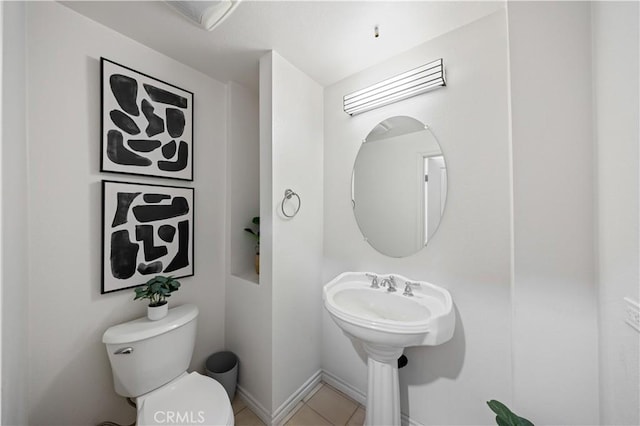 bathroom with tile patterned floors and toilet