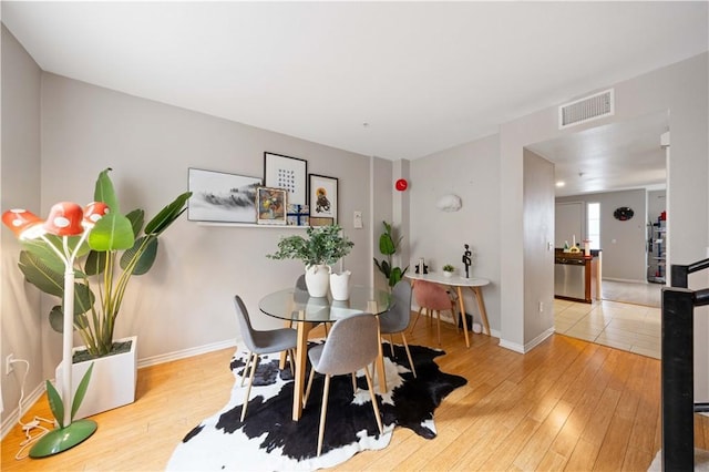 dining space featuring light hardwood / wood-style floors