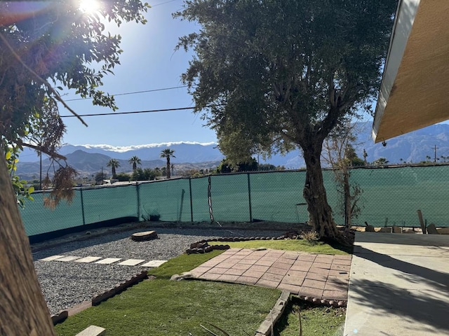 view of yard featuring a mountain view and a patio area