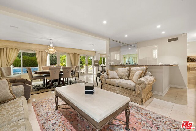 living room featuring french doors and light tile patterned flooring