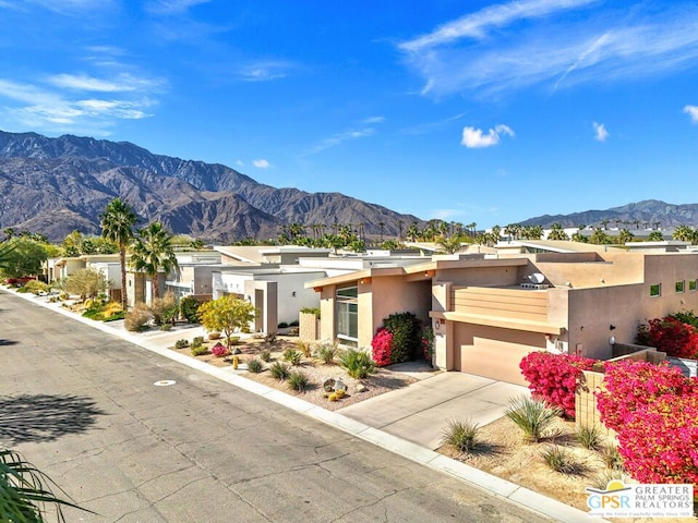 view of front of property with a garage and a mountain view