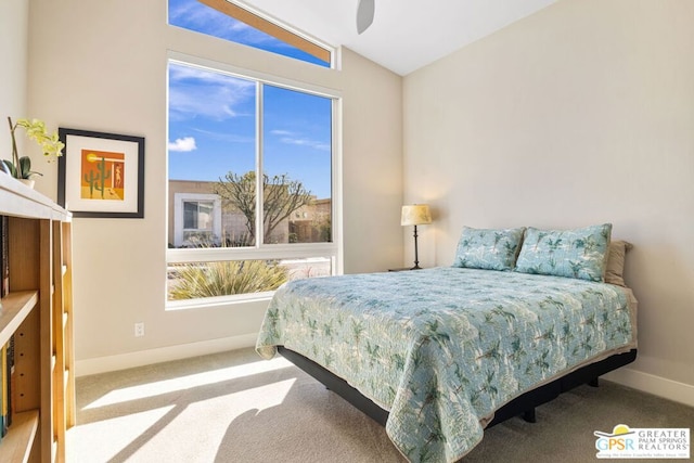 bedroom with ceiling fan, lofted ceiling, and carpet floors