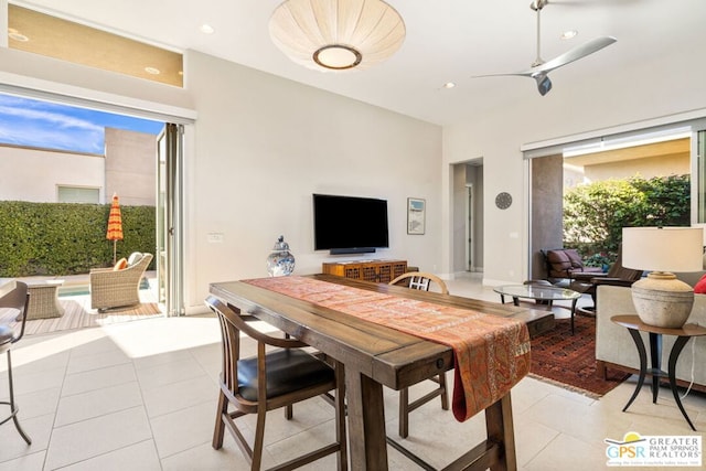 dining space featuring ceiling fan and light tile patterned floors